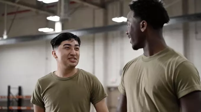 Two Men In Military Gear Conversing